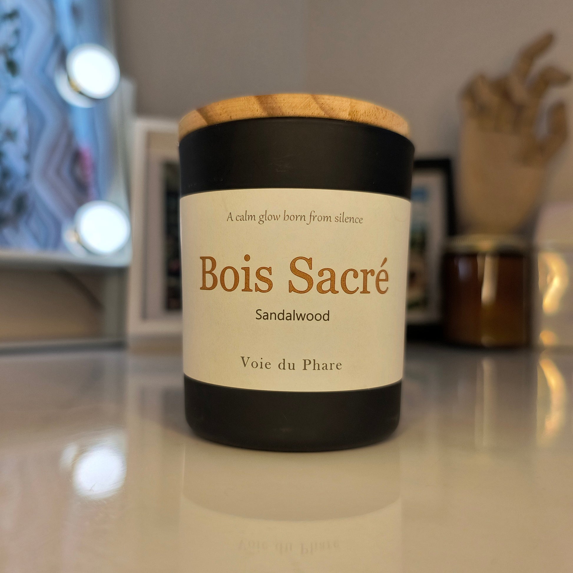 Candle with a label on a reflective surface