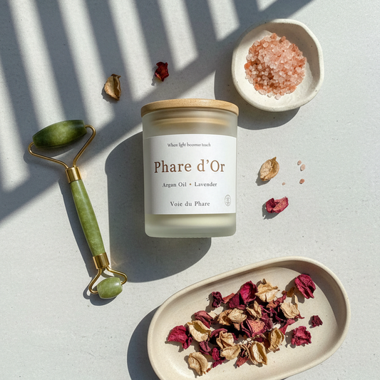 Candle labeled 'Phare d'Or' with decorative elements on a light surface